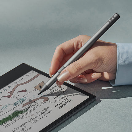 Hand using the Onyx Boox InkSense Plus stylus to write notes on a BOOX e-reader screen