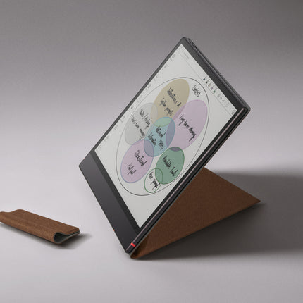 Onyx Boox Note Air6 C e-reader standing in an umber smart cover, with a stylus loop beside it