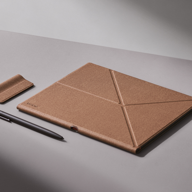 Umber Onyx Boox smart cover for the Note Air6 C with a stylus and holder loop on a grey surface