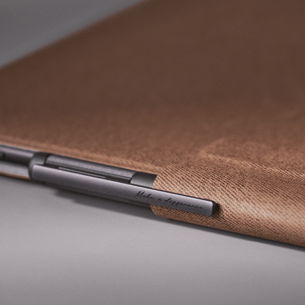 Close-up of the umber Onyx Boox smart cover edge with a stylus attached