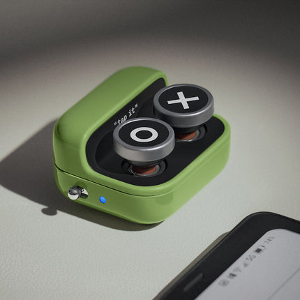 Green BOOX Tappy page turner with two round buttons on a table beside a BOOX e-reader