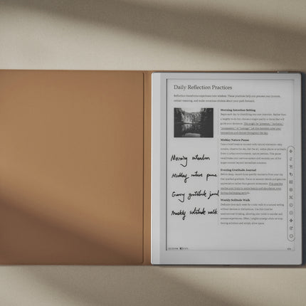 Onyx Boox Go 10.3 e-reader with its tan smart cover folded open beside the screen, with a stylus on the desk